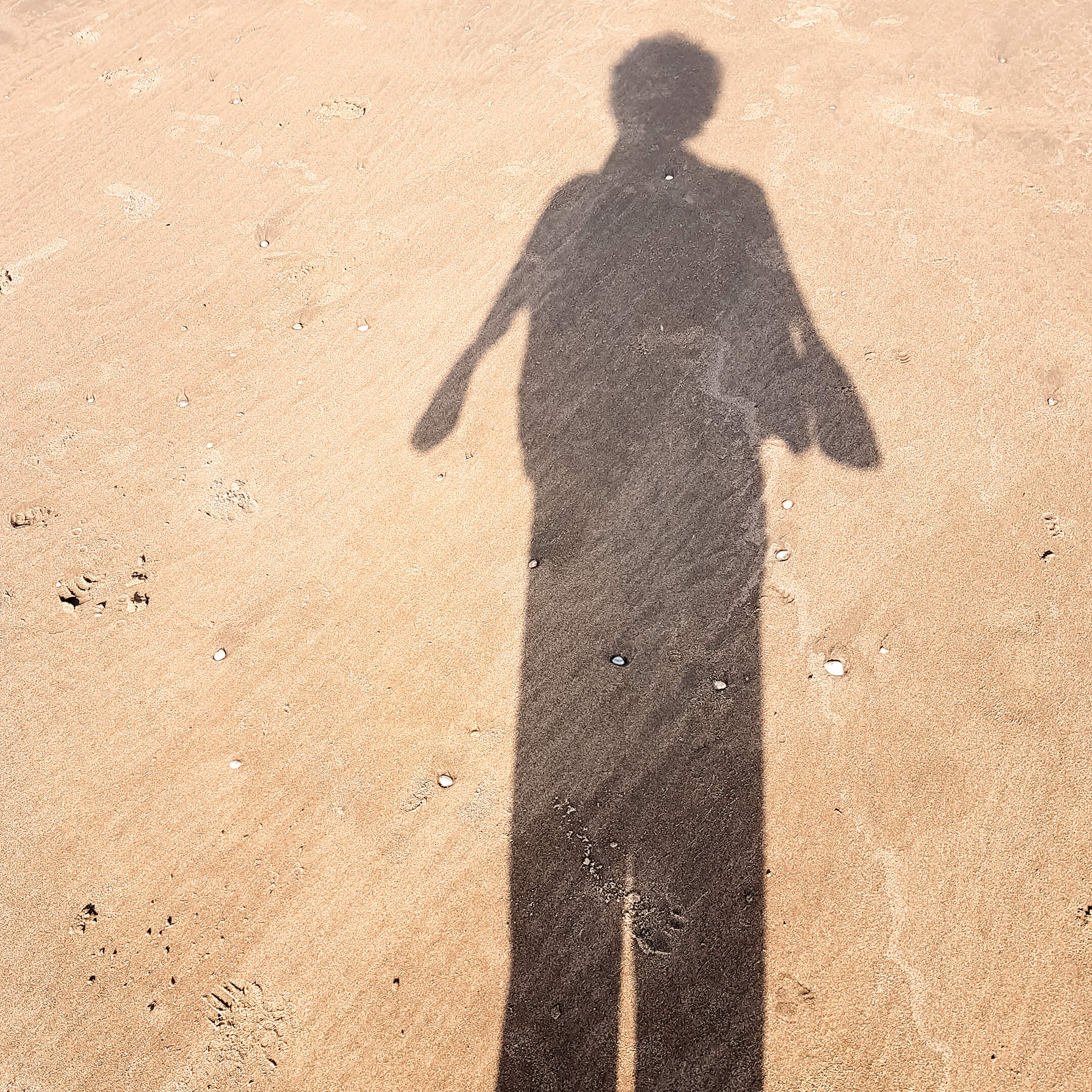 Foto van mijn schaduw op het strand. De foto hoort bij mijn gedicht overhet bedenken (en vergeten) van een gedicht op het strand.